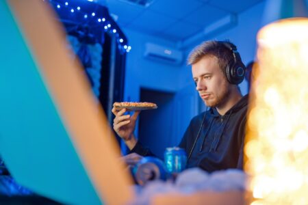 Male Gamer Eating Pizza, Night Tournament